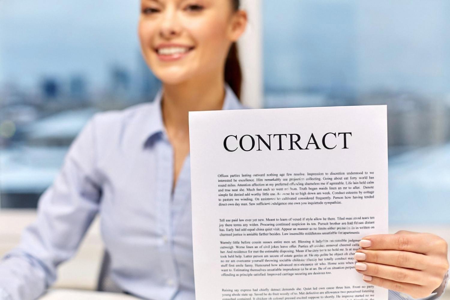 Smiling candidate holding a signed employment contract in a UAE office